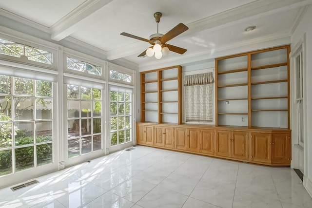 unfurnished sunroom featuring a healthy amount of sunlight, beamed ceiling, and ceiling fan