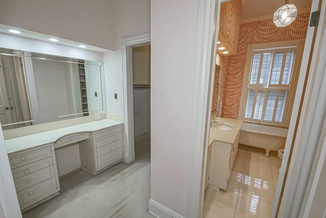 1521 Dufossat St, New Orleans, LA 70115 - bathroom featuring vanity, a soaking tub, and baseboards