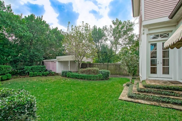 view of yard featuring french doors and a shed