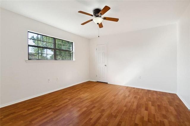 spare room with wood-type flooring and ceiling fan