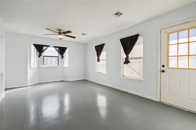 unfurnished room with a textured ceiling and ceiling fan