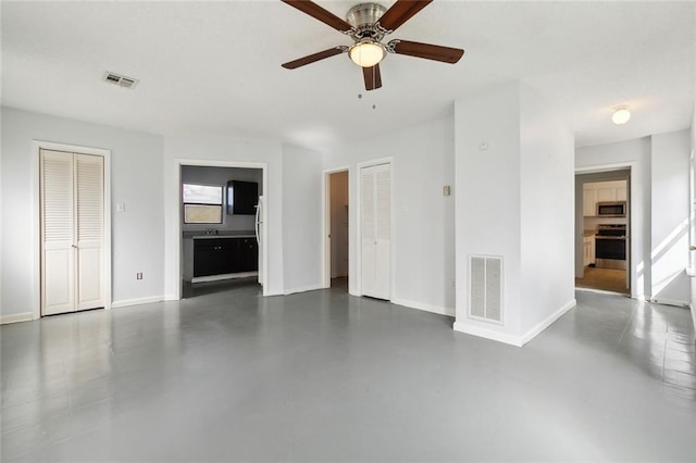 unfurnished living room with ceiling fan and a healthy amount of sunlight