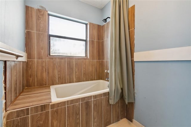 bathroom with shower / bath combination with curtain