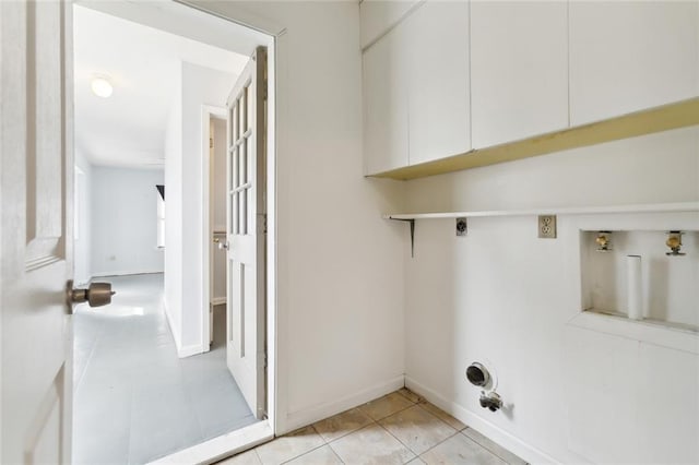 washroom featuring cabinets, light tile patterned floors, hookup for a washing machine, and electric dryer hookup