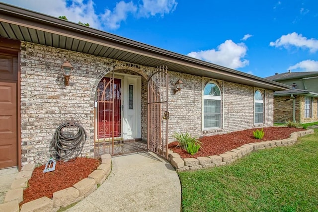 entrance to property with a lawn