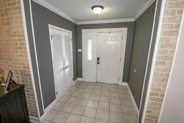 entryway with light tile patterned floors, crown molding, and brick wall