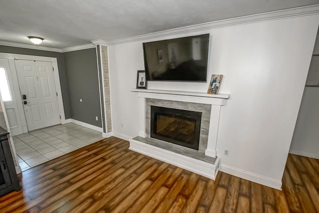 unfurnished living room with ornamental molding and light hardwood / wood-style floors