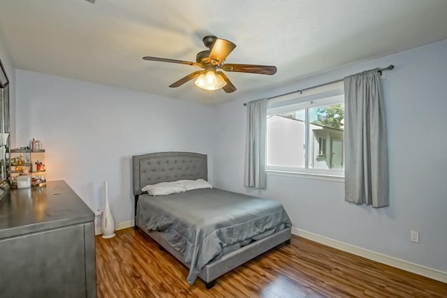 bedroom with dark wood-type flooring and ceiling fan