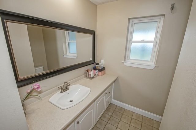 bathroom with vanity, toilet, and tile patterned flooring