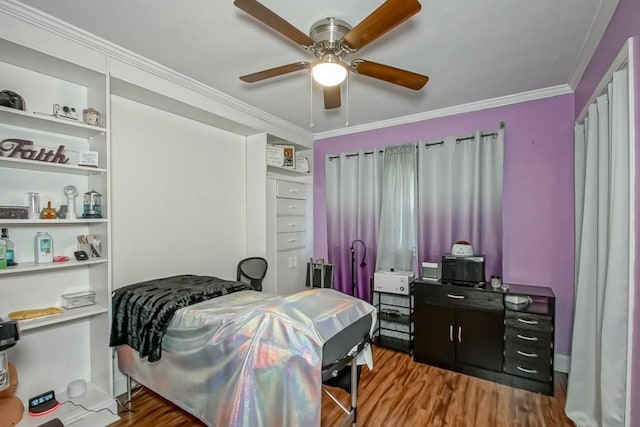 bedroom featuring crown molding, wood-type flooring, and ceiling fan