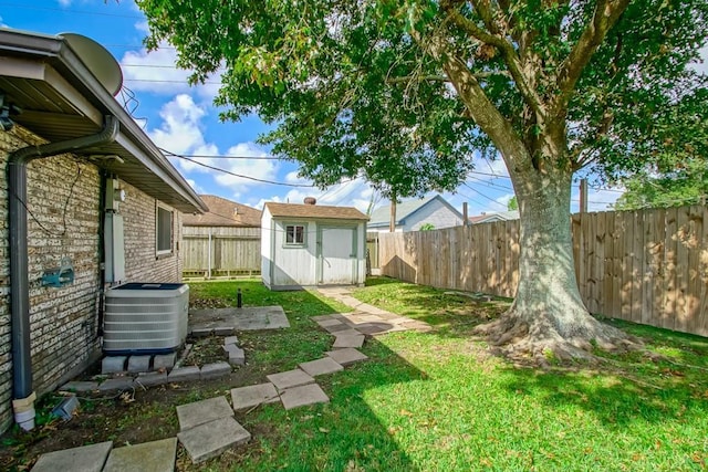 view of yard with central AC and a storage unit