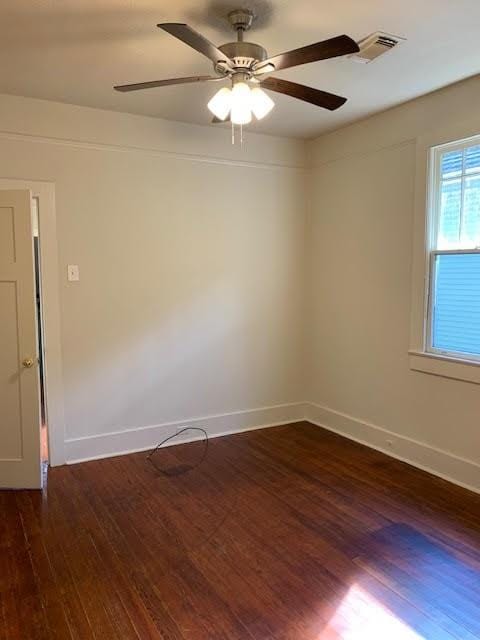 unfurnished room featuring dark hardwood / wood-style flooring and ceiling fan