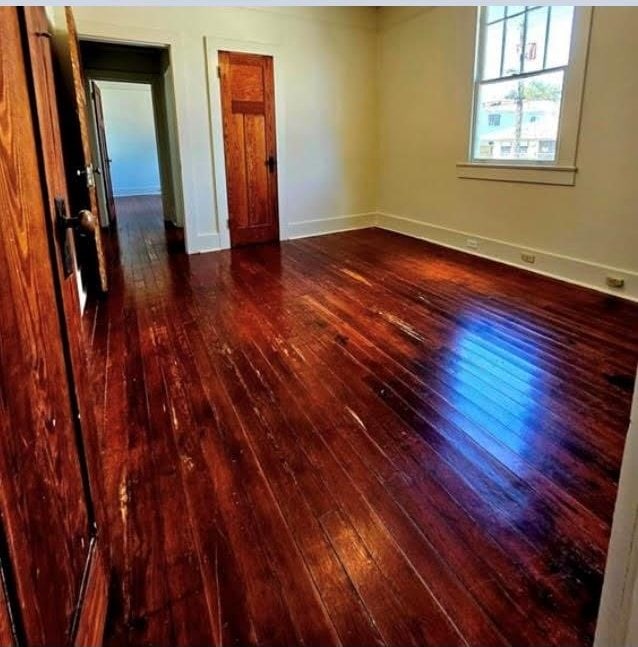 unfurnished room with dark hardwood / wood-style floors