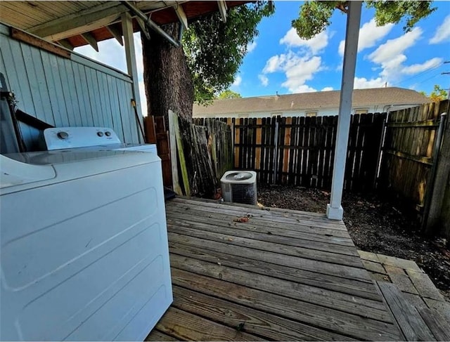 wooden terrace featuring washer / dryer and central AC unit