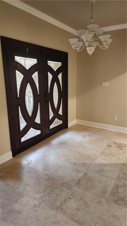 entrance foyer featuring a chandelier, french doors, and ornamental molding