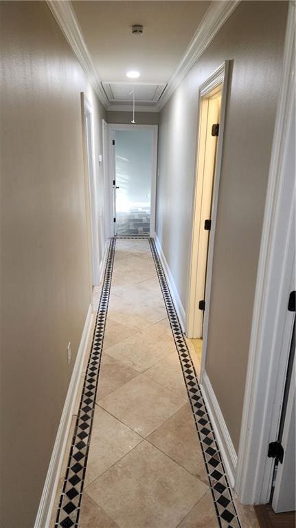 corridor featuring ornamental molding and light tile patterned flooring