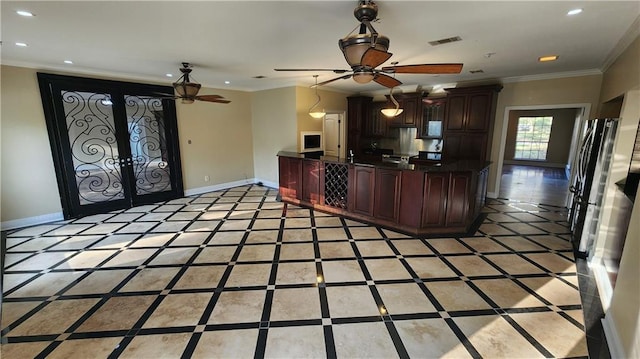 kitchen with dark brown cabinets, stainless steel refrigerator, french doors, and ornamental molding