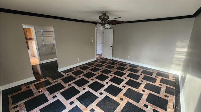 spare room featuring ceiling fan and ornamental molding