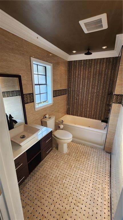 bathroom with ornamental molding, vanity, and toilet