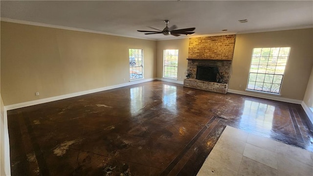 unfurnished living room featuring a fireplace, a healthy amount of sunlight, and crown molding