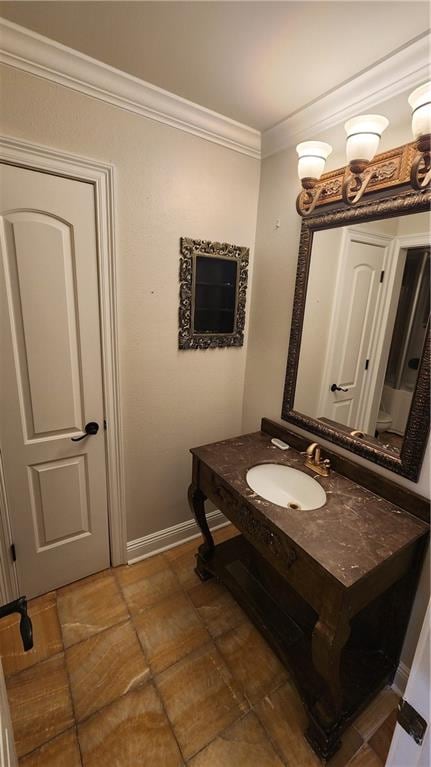 bathroom featuring sink and crown molding