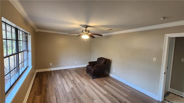 unfurnished room with ornamental molding, light wood-type flooring, and ceiling fan