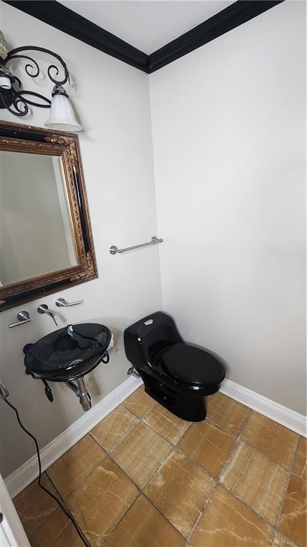 bathroom with toilet, tile patterned flooring, and ornamental molding