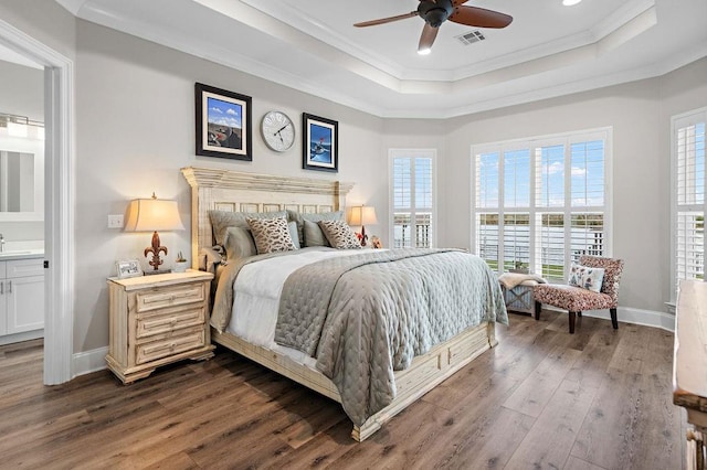 bedroom featuring dark wood-type flooring, ornamental molding, multiple windows, and ceiling fan