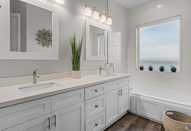 bathroom featuring vanity, a tub, and hardwood / wood-style flooring