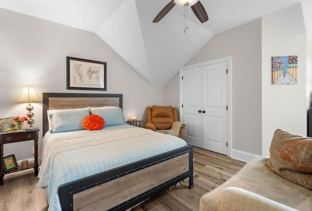 bedroom featuring ceiling fan, light wood-type flooring, and vaulted ceiling