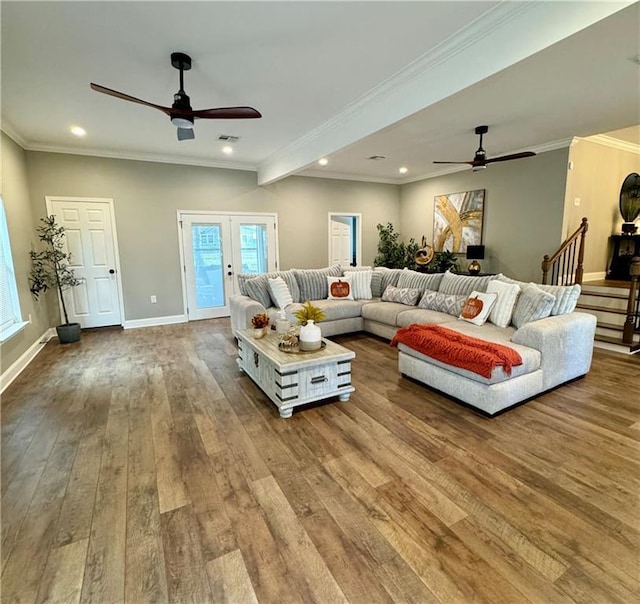 living room with french doors, crown molding, and light hardwood / wood-style flooring