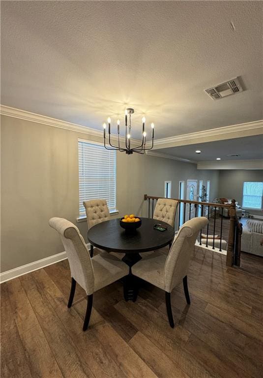 dining space with a notable chandelier, dark hardwood / wood-style floors, and crown molding