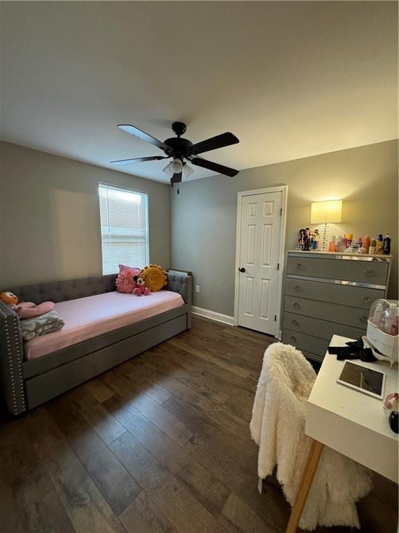 bedroom with ceiling fan and dark wood-type flooring