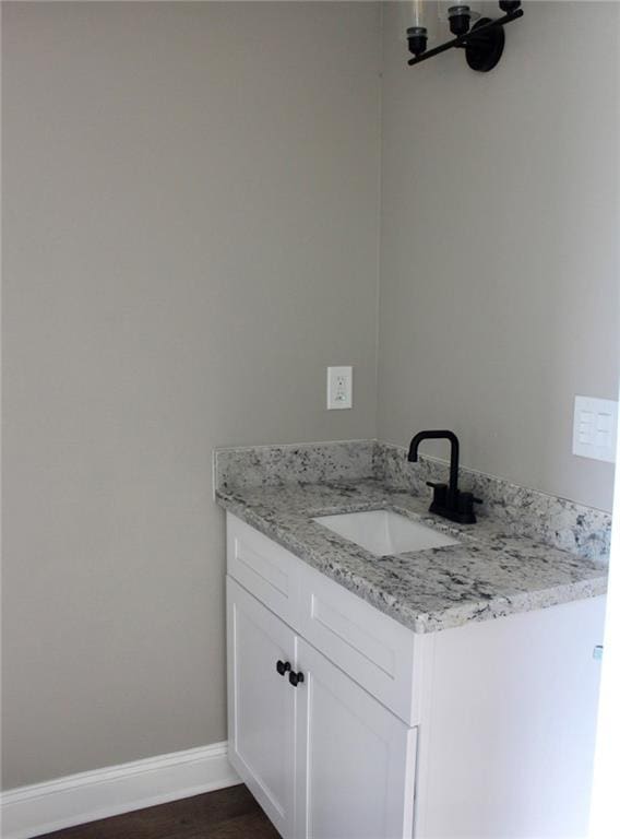 bathroom with hardwood / wood-style floors and vanity