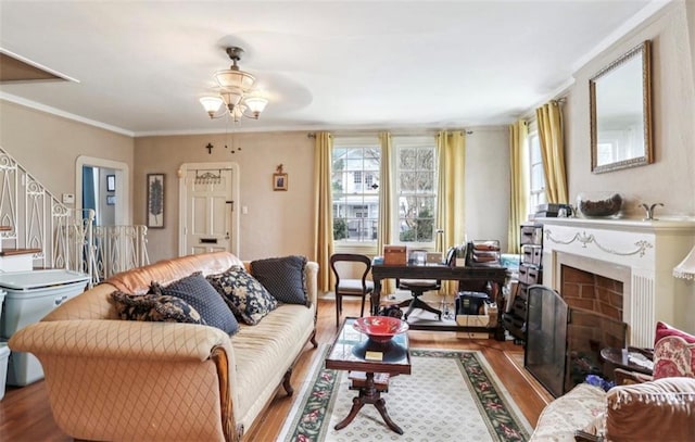 living room with hardwood / wood-style flooring, ceiling fan, and crown molding