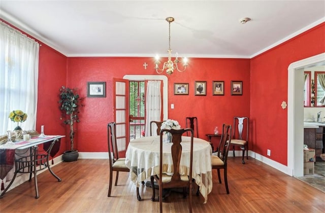 dining area featuring hardwood / wood-style flooring, plenty of natural light, and a notable chandelier