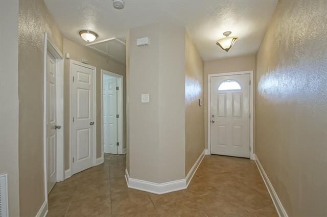 doorway to outside featuring tile patterned floors