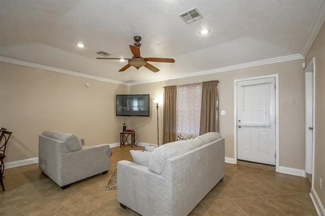 tiled living room with ornamental molding and ceiling fan