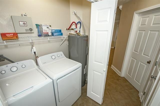 laundry area featuring separate washer and dryer, water heater, and light tile patterned flooring