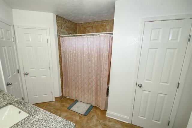 bathroom with vanity and tile patterned flooring