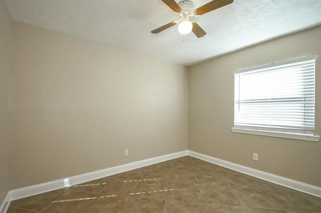 tiled empty room with ceiling fan