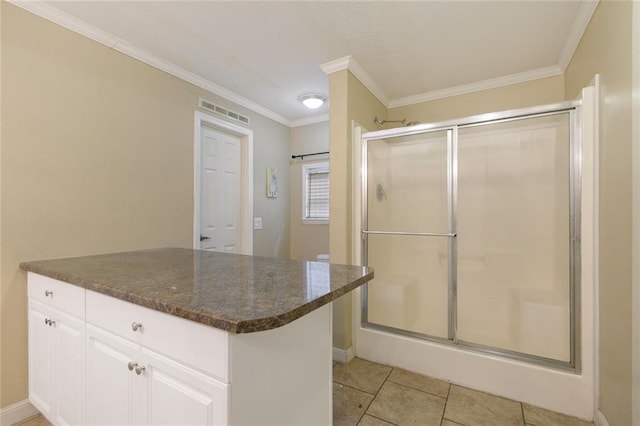bathroom with a stall shower, visible vents, tile patterned flooring, and ornamental molding