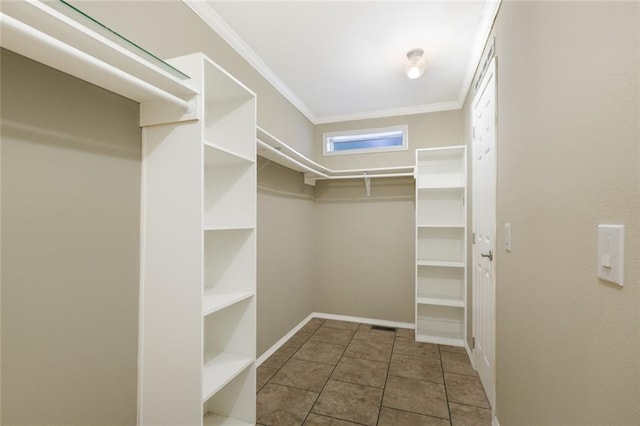 walk in closet with tile patterned flooring
