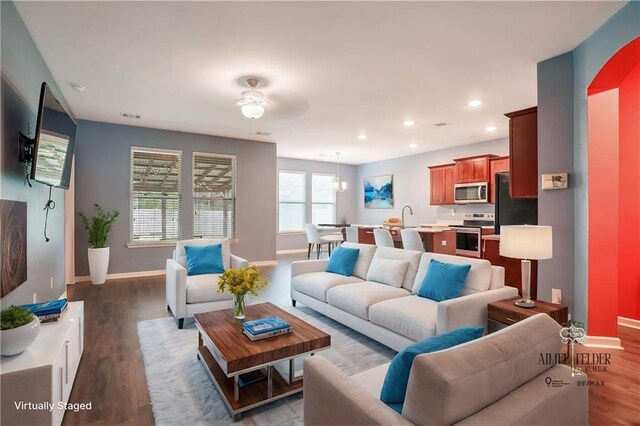 living room with sink, hardwood / wood-style floors, and ceiling fan