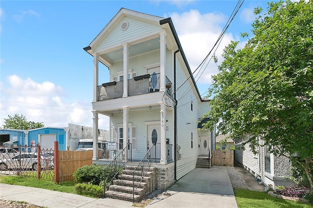 view of front facade featuring a balcony and a porch