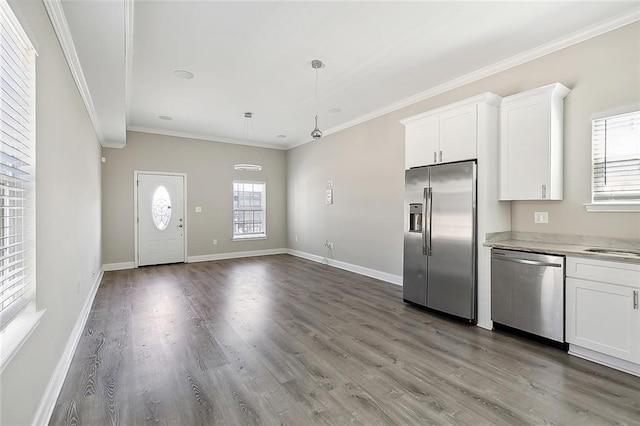 kitchen with plenty of natural light, white cabinets, and stainless steel appliances