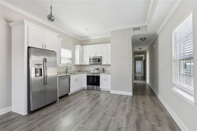 kitchen with light hardwood / wood-style flooring, white cabinetry, sink, and stainless steel appliances