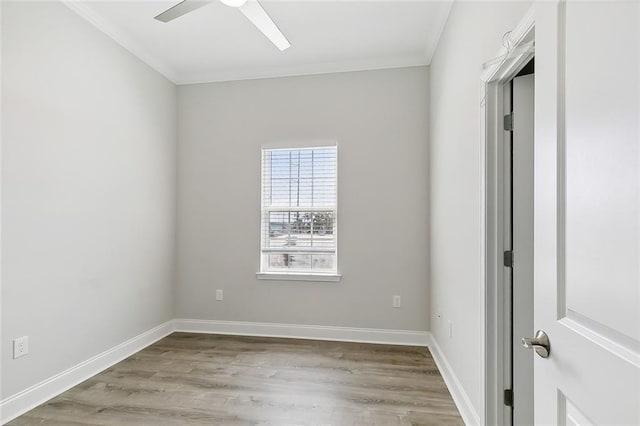 spare room featuring ceiling fan, light wood-type flooring, and crown molding