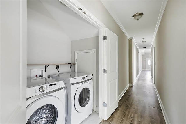 clothes washing area with hardwood / wood-style floors, separate washer and dryer, and ornamental molding