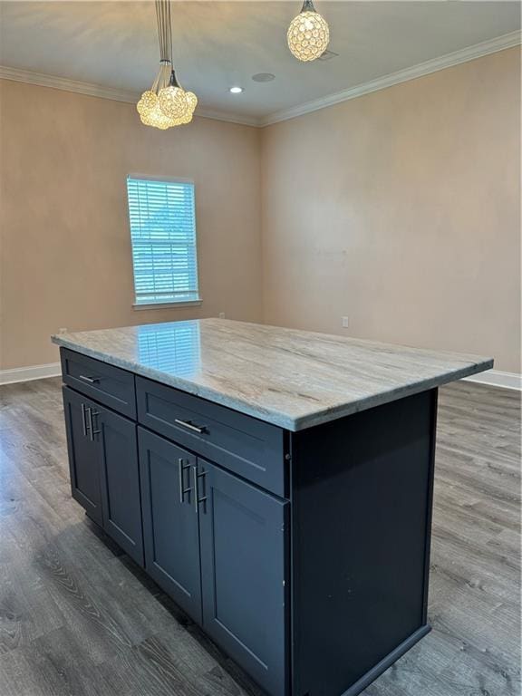 kitchen with dark wood-type flooring, decorative light fixtures, crown molding, and a center island